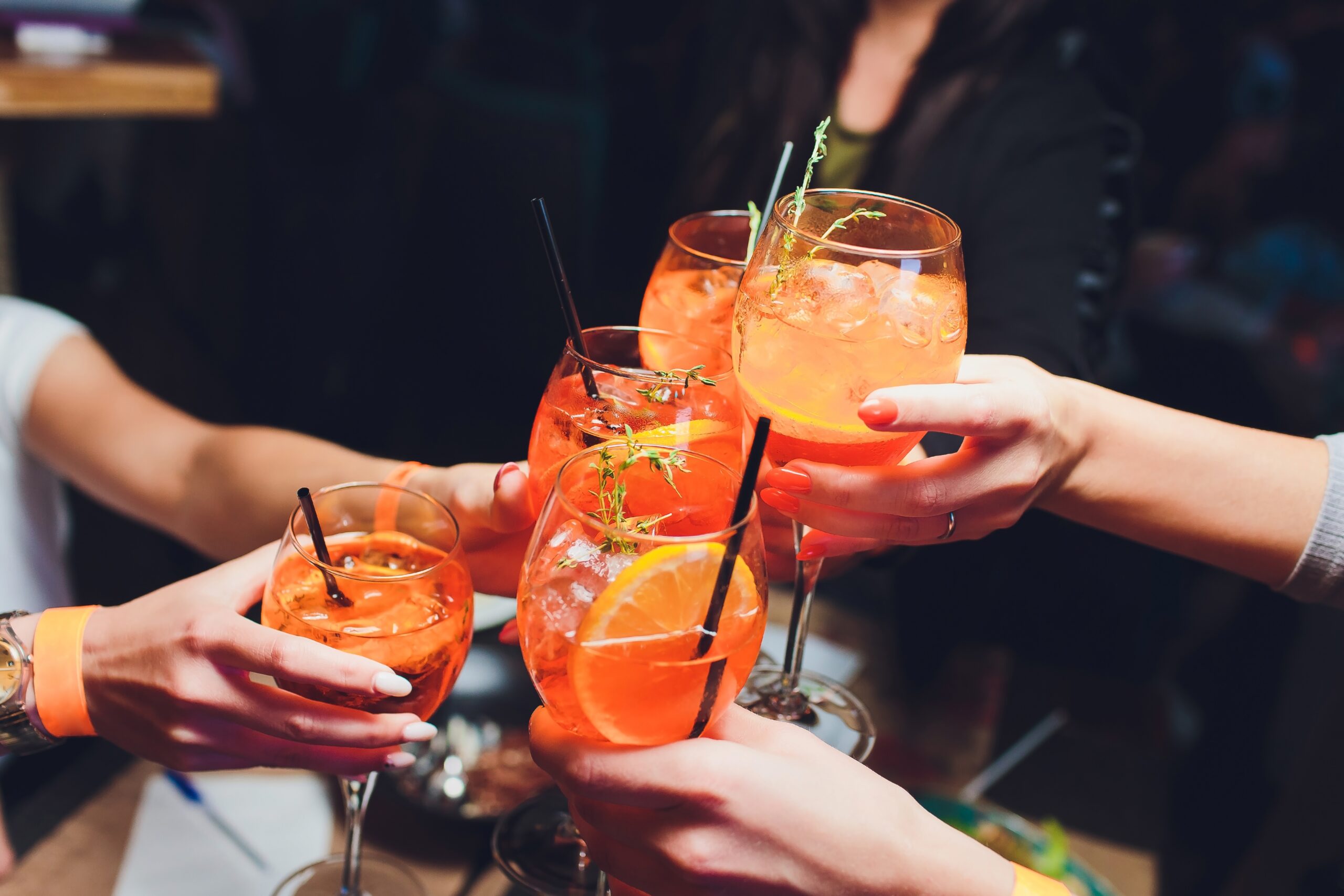 Women,Raising,A,Glasses,Of,Aperol,Spritz,At,The,Dinner